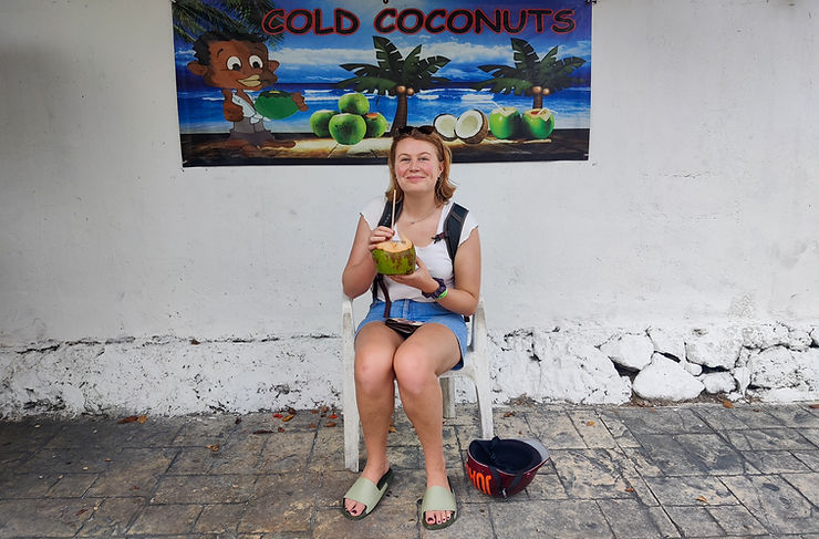 Billie drinking a coconut